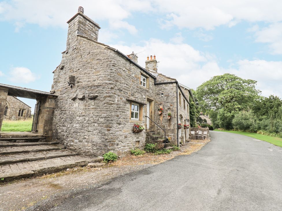 A stone house with steps leading to the entrance at The Stables in Horton-in-Ribblesdale near Settle