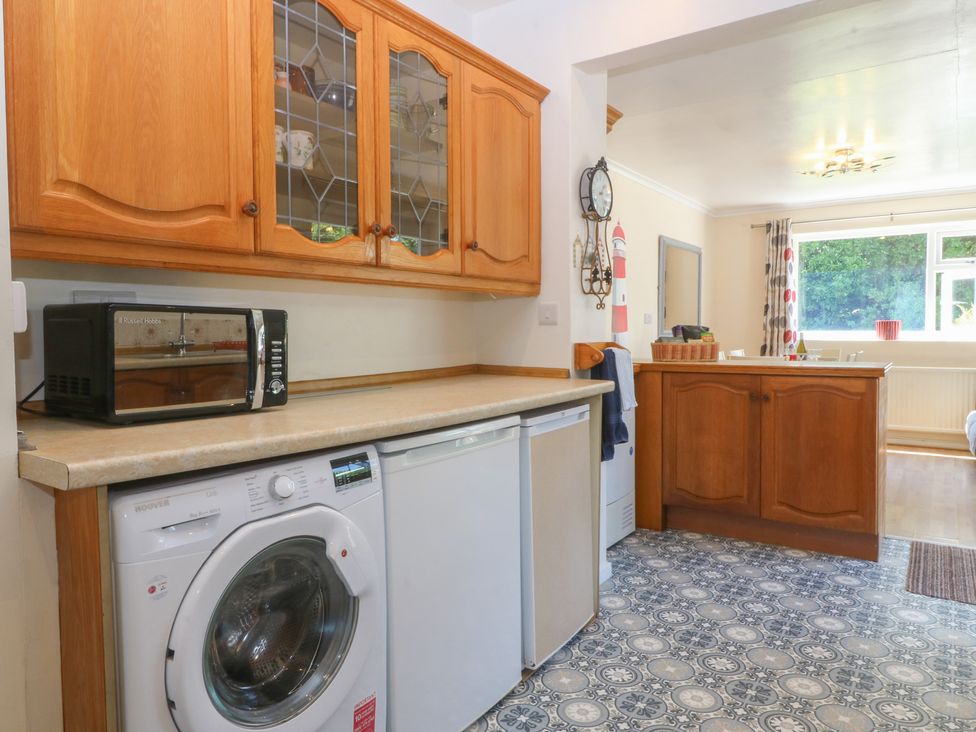 A kitchen with appliances and cabinetry at Salty Puffin in Benllech
