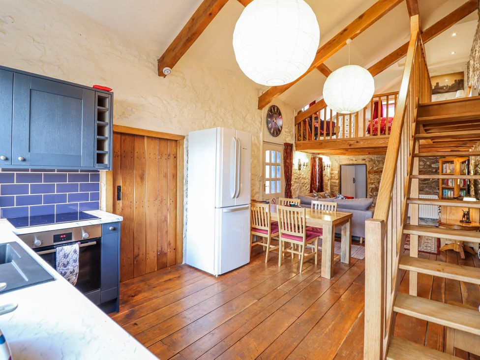 A kitchen with a dining table and chairs at Dovetail Cottage in Llangollen