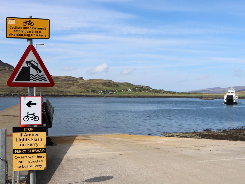 A ferry slipway with warning signs at MacKenzie’s Peak in Sconser near Portree