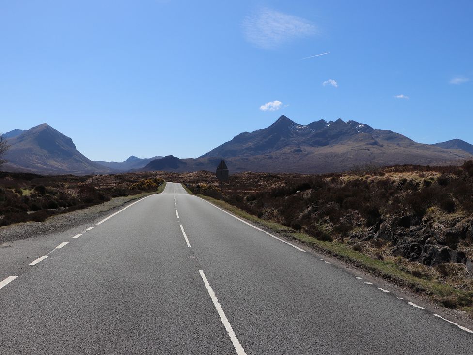A road with mountains in the background at MacKenzie’s Peak Sconser near Portree