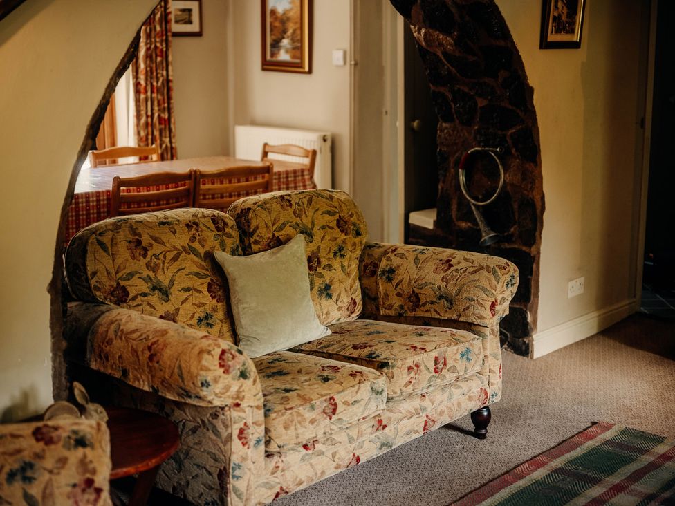 A living room with a sofa and table at The Wilderness in Stiperstones