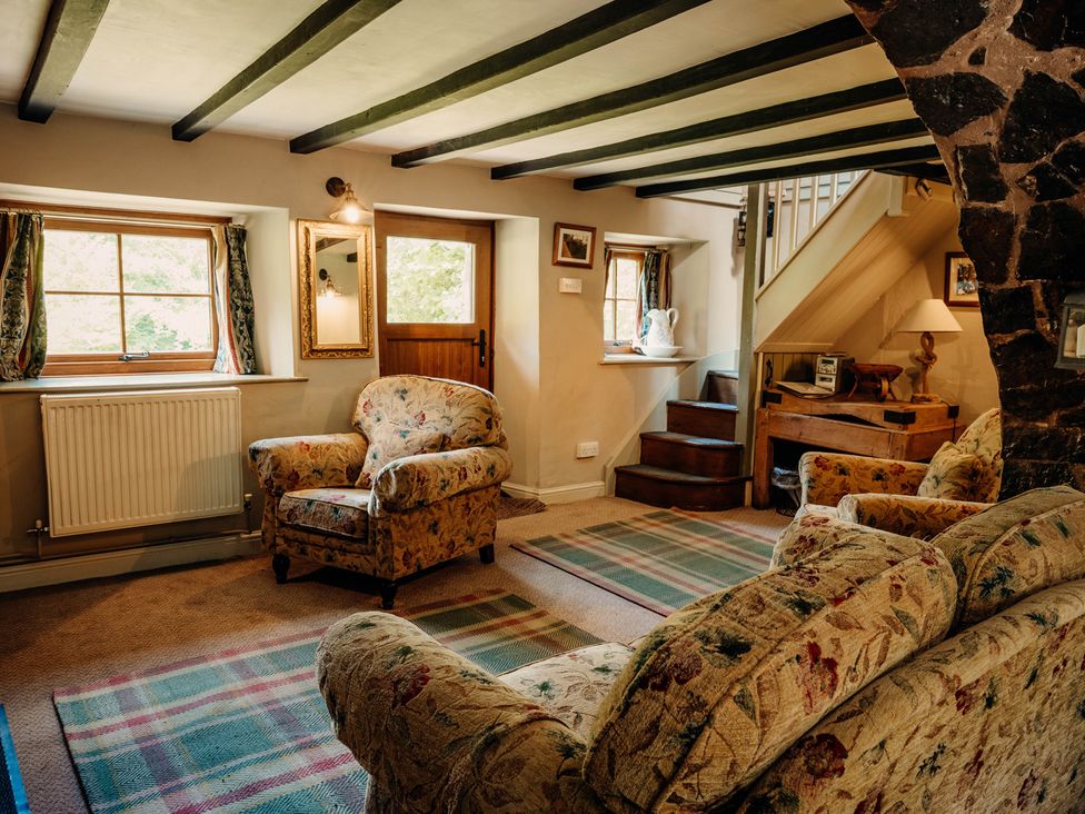 A living room with a sofa and armchair at The Wilderness Stiperstones