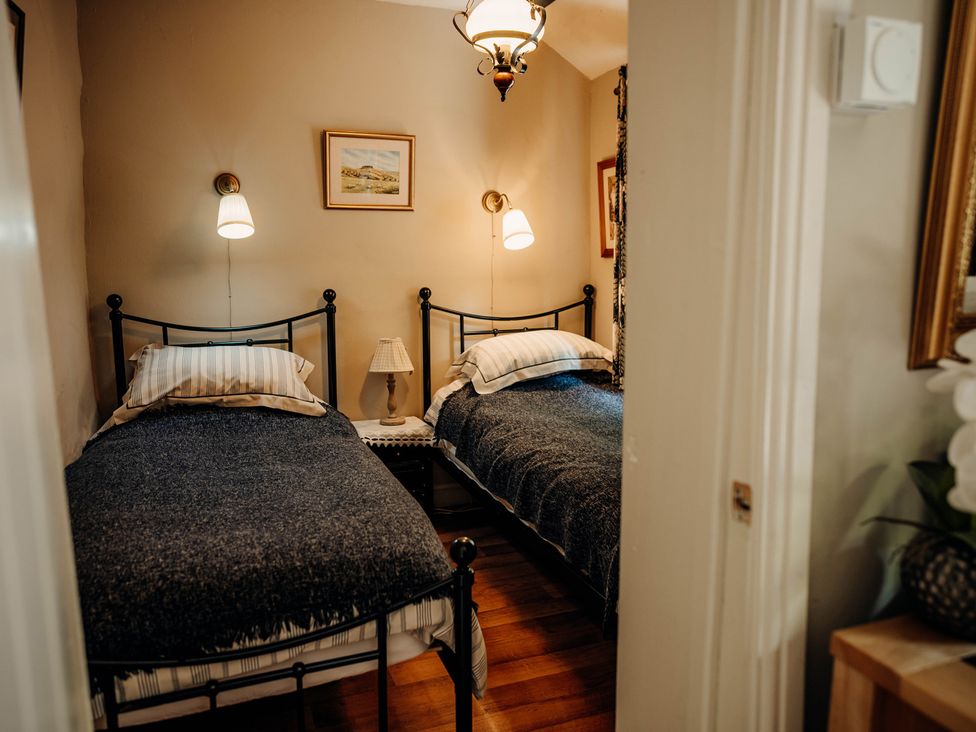 A bedroom with two beds and a table at The Wilderness in Stiperstones