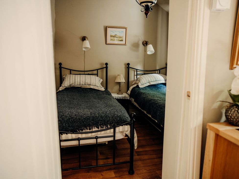 A bedroom with two beds and a nightstand at The Wilderness in Stiperstones