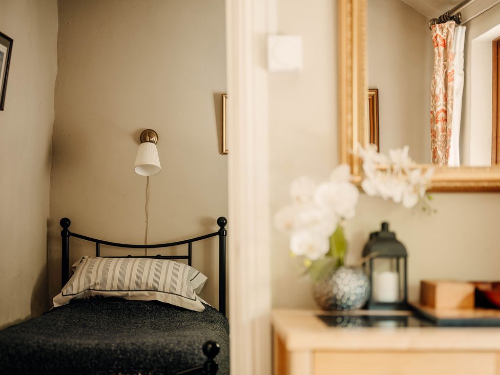 A bedroom with a bed and decorative items at The Wilderness in Stiperstones