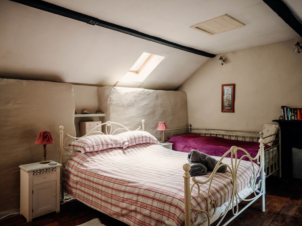 A bedroom with two beds and a skylight at The Wilderness Stiperstones