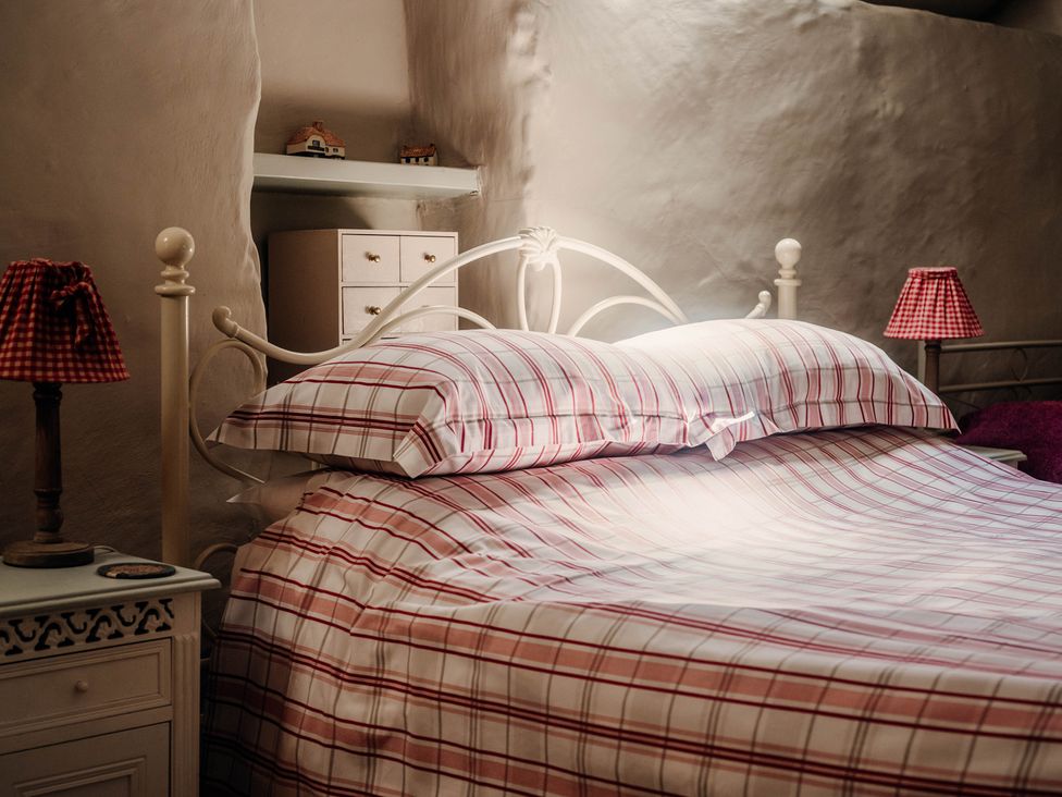 A bedroom with a bed and two lamps at The Wilderness in Stiperstones
