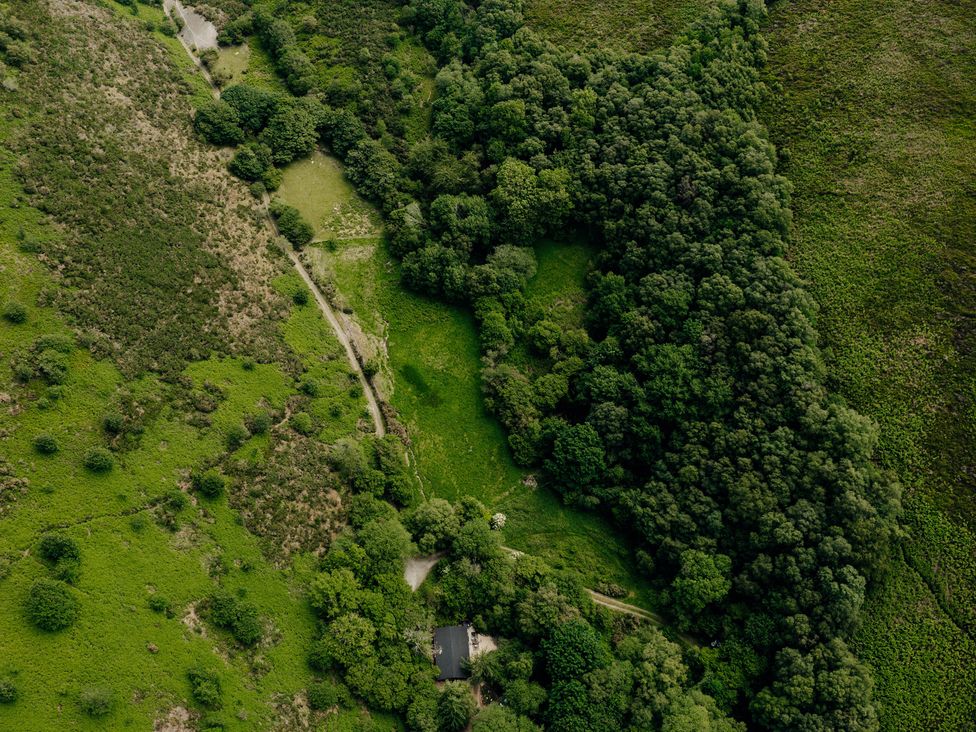 An aerial view of a house surrounded by greenery at The Wilderness, Stiperstones