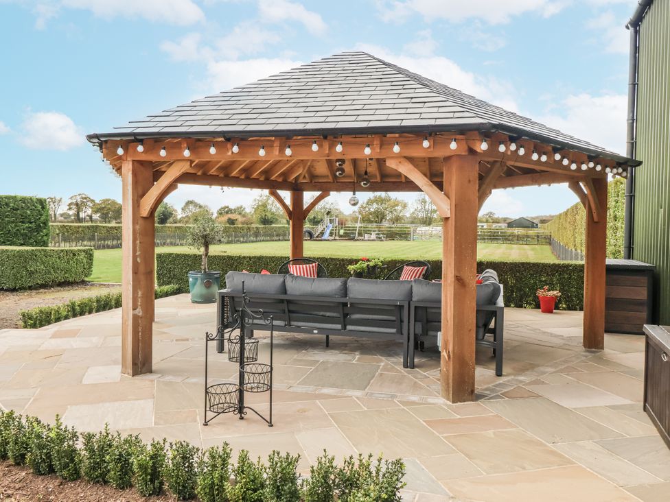 A gazebo with a couch in the backyard at Pear Tree Cottage in Dunnington