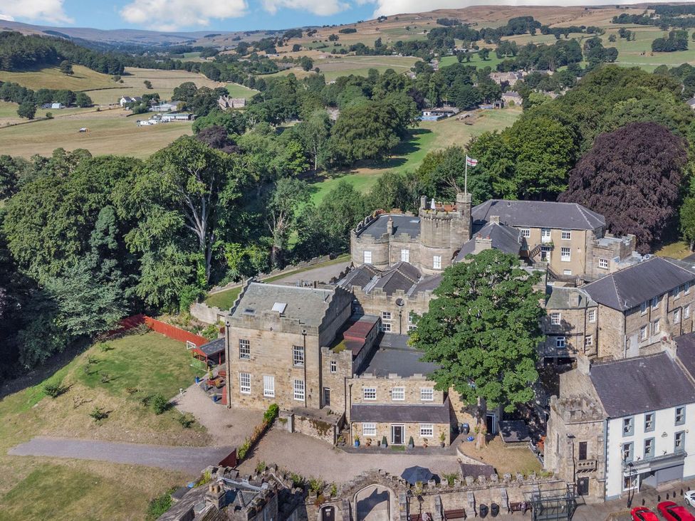 An aerial view of a castle surrounded by trees and fields at Knights Corner Stanhope Castle in Stanhope