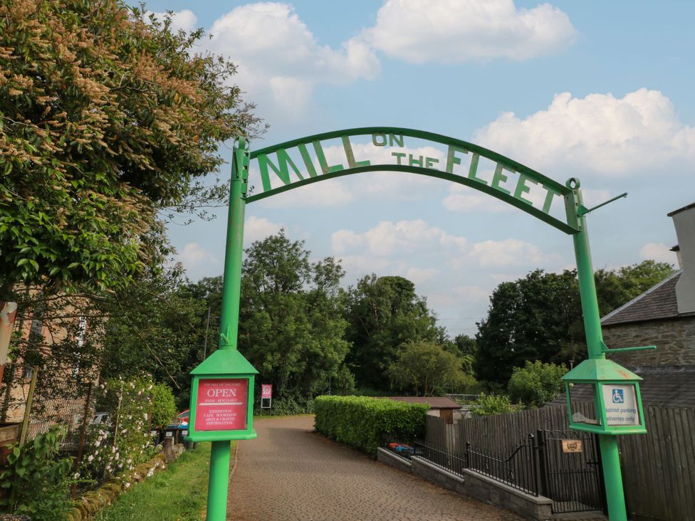 An archway with a sign reading Mill on the Fleet at Mill on the Fleet in Gatehouse of Fleet