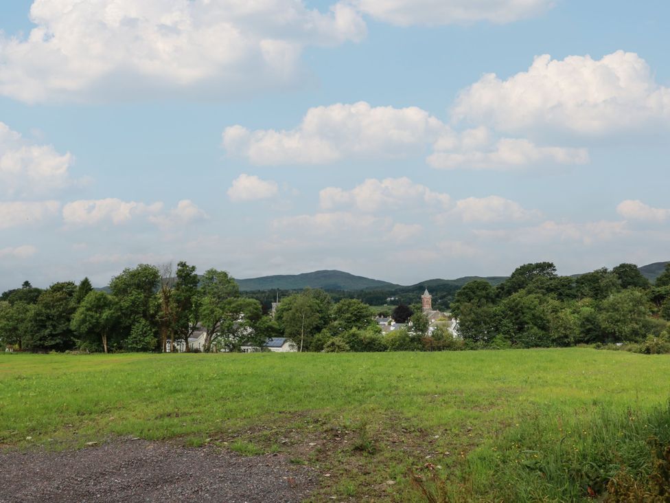 A view of green grass and trees with a village in the background at 79 Laurel Bank Gatehouse of Fleet