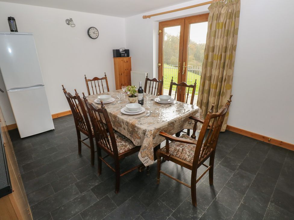 A dining room with a table set for a meal at Bwthyn-y-Rhiw Penybanc near Llandeilo