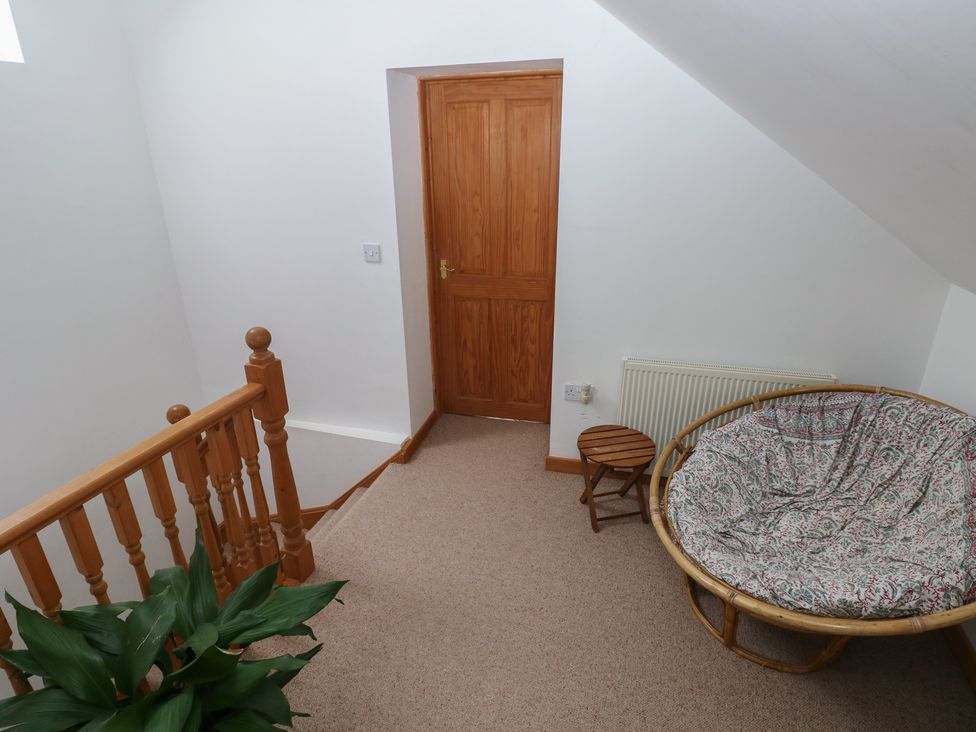 A landing with a staircase and a chair at Bwthyn-y-Rhiw Penybanc near Llandeilo