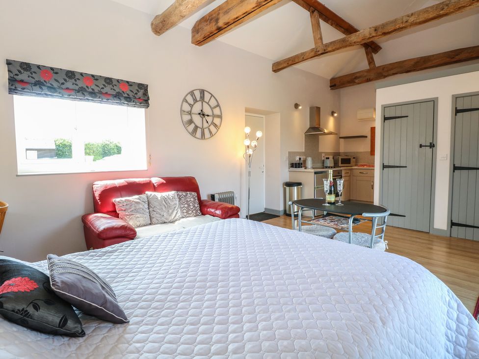 A studio with a bed and kitchenette at Snowy Owl Barn in Shipdham