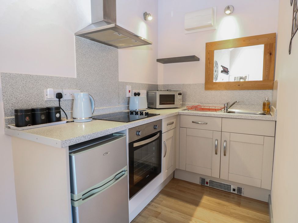 A kitchen with appliances and cabinetry at Snowy Owl Barn in Shipdham