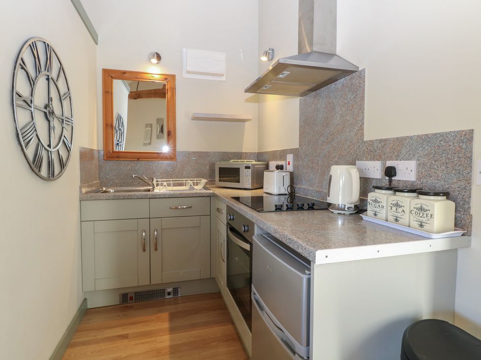 A kitchen with appliances and storage at Tawny Owl Barn Shipdham near Dereham
