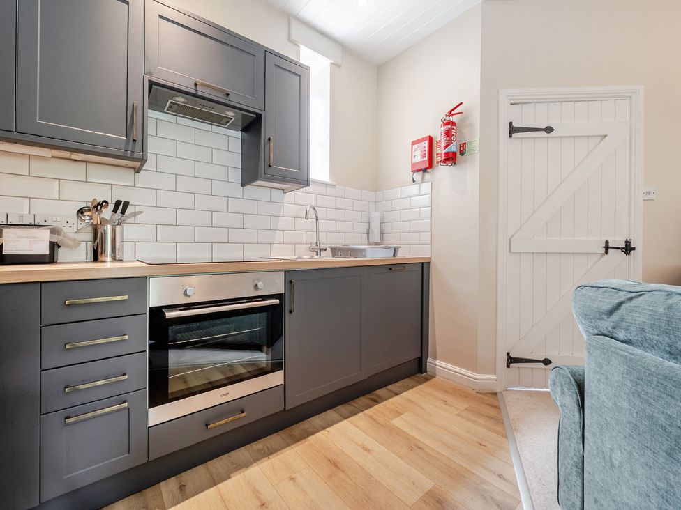 A kitchen with oven and sink at Can Brow at the Graythwaite Estate near Hawkshead