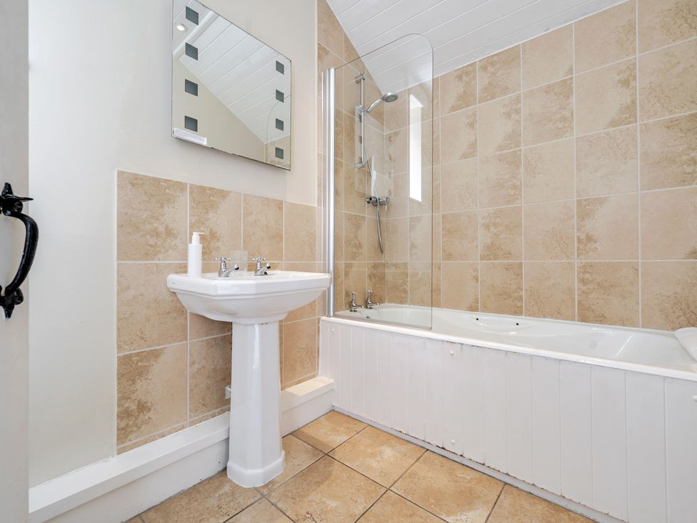 A bathroom with a bathtub and sink at Can Brow at the Graythwaite Estate near Hawkshead