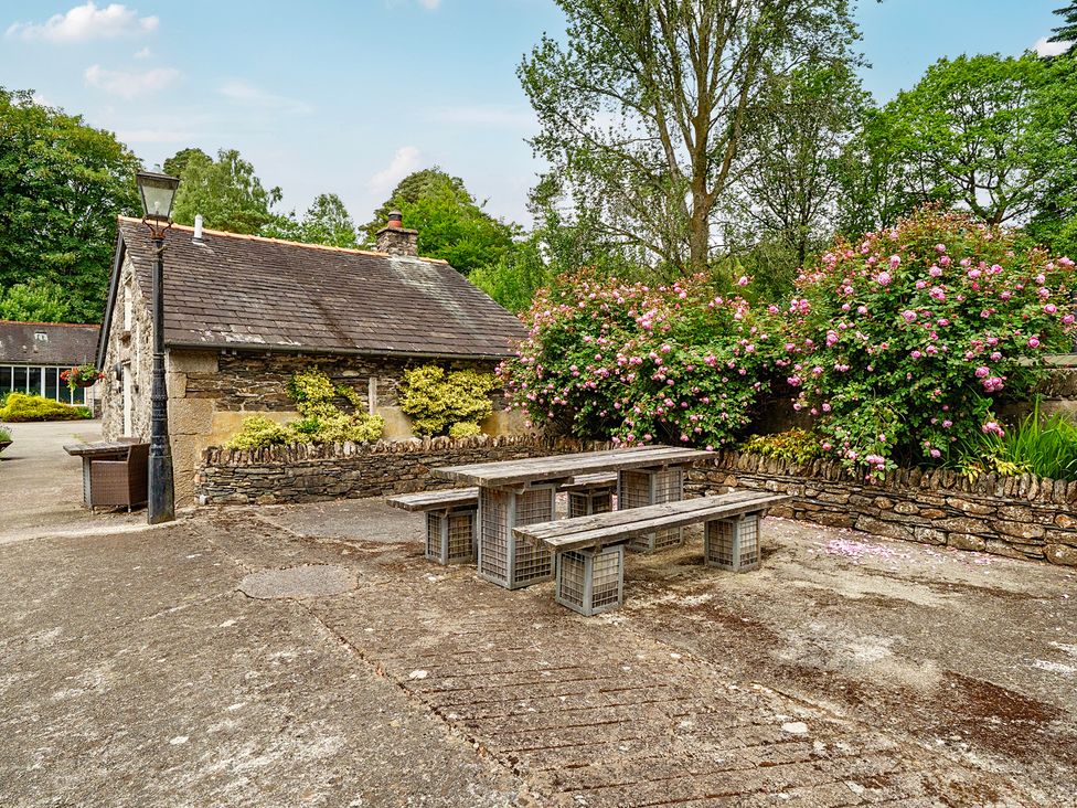 An outdoor area with a table and chairs at Can Brow at the Graythwaite Estate near Hawkshead