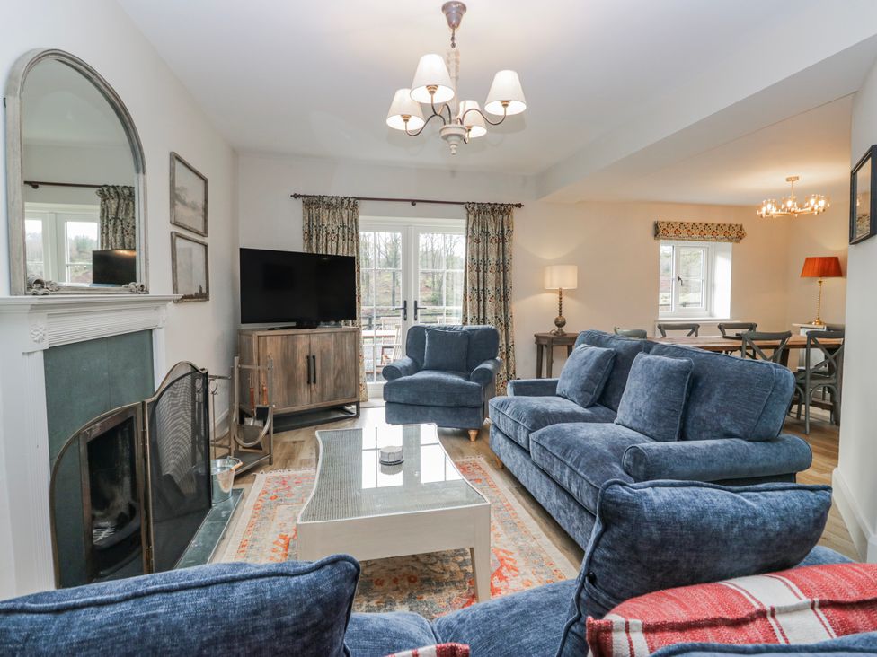 A living room with a sofa and a television at Jubilee near Graythwaite