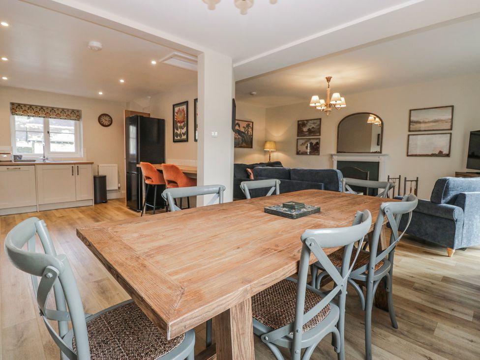 A dining room with a wooden table and chairs at Jubilee near Hawkshead