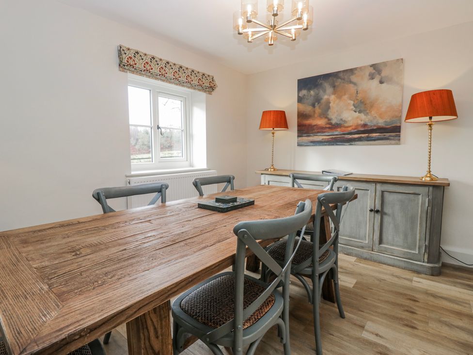 A dining room with a wooden table and chairs at Jubilee in Graythwaite near Hawkshead