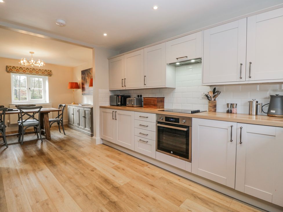 A kitchen with cabinets and dining area at Jubilee in Graythwaite near Hawkshead