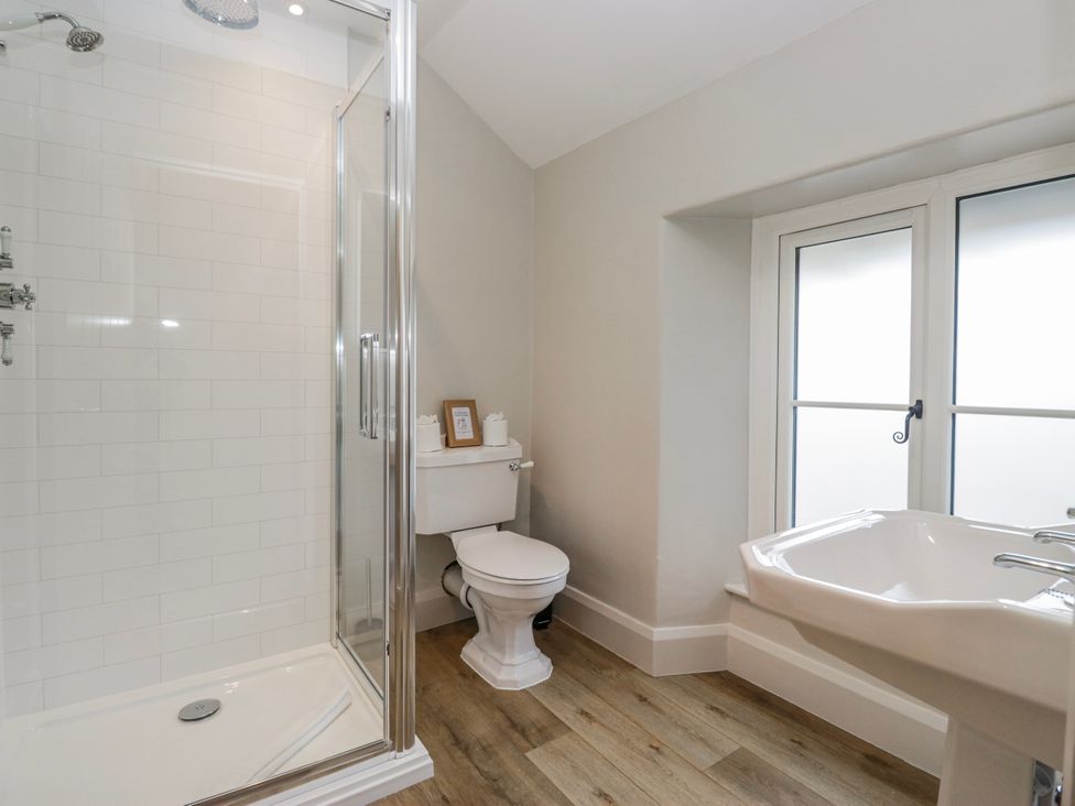 A bathroom with a shower, toilet, and sink at Jubilee in Graythwaite near Hawkshead