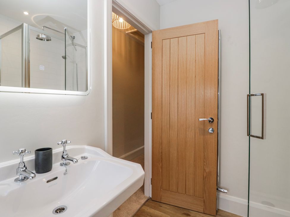 A bathroom with a wash basin and a shower at Jubilee in Graythwaite near Hawkshead