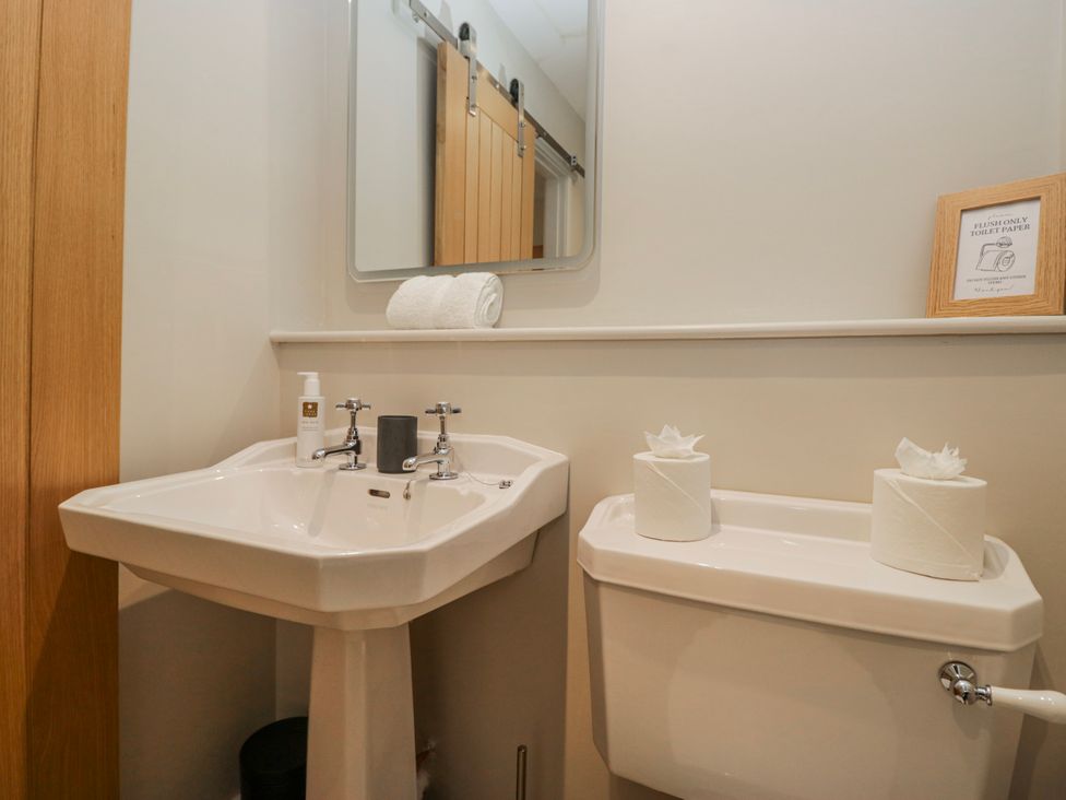 A bathroom with a sink and toilet at Jubilee in Graythwaite near Hawkshead