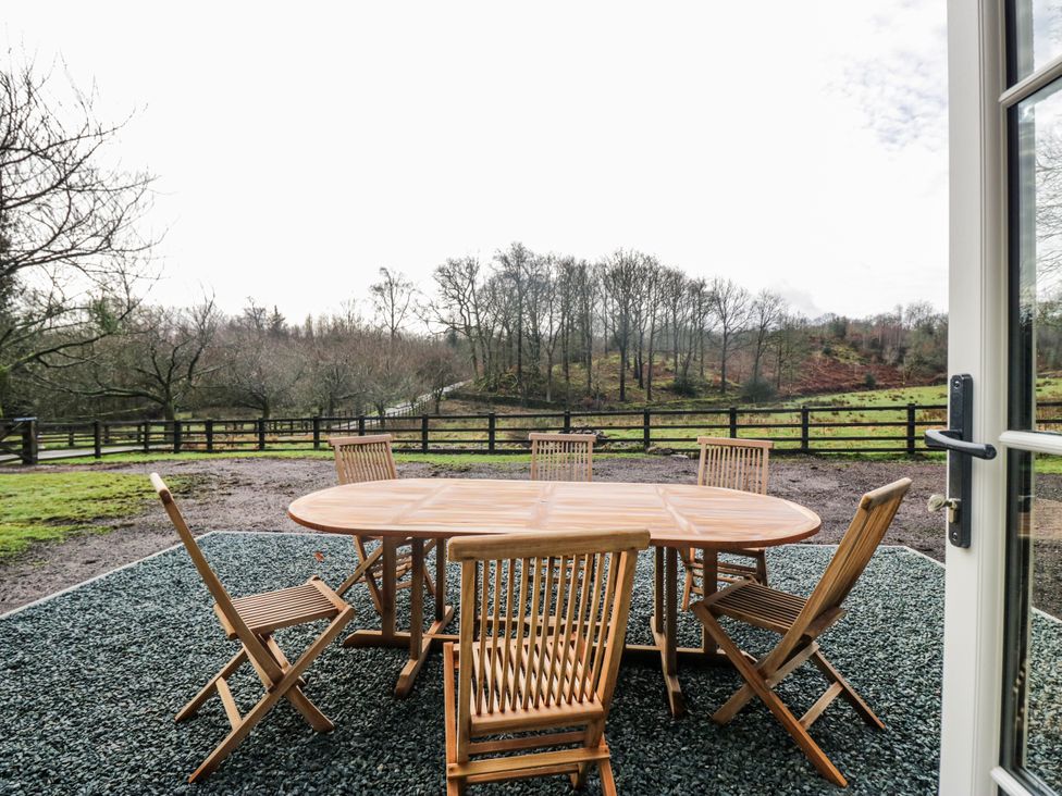 An outdoor dining area with a table and chairs at Jubilee near Graythwaite