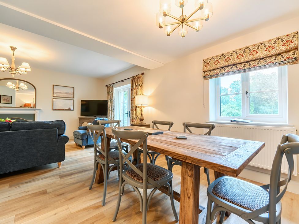 A dining room with a table and chairs at Jubilee at the Graythwaite Estate in Graythwaite near Hawkshead