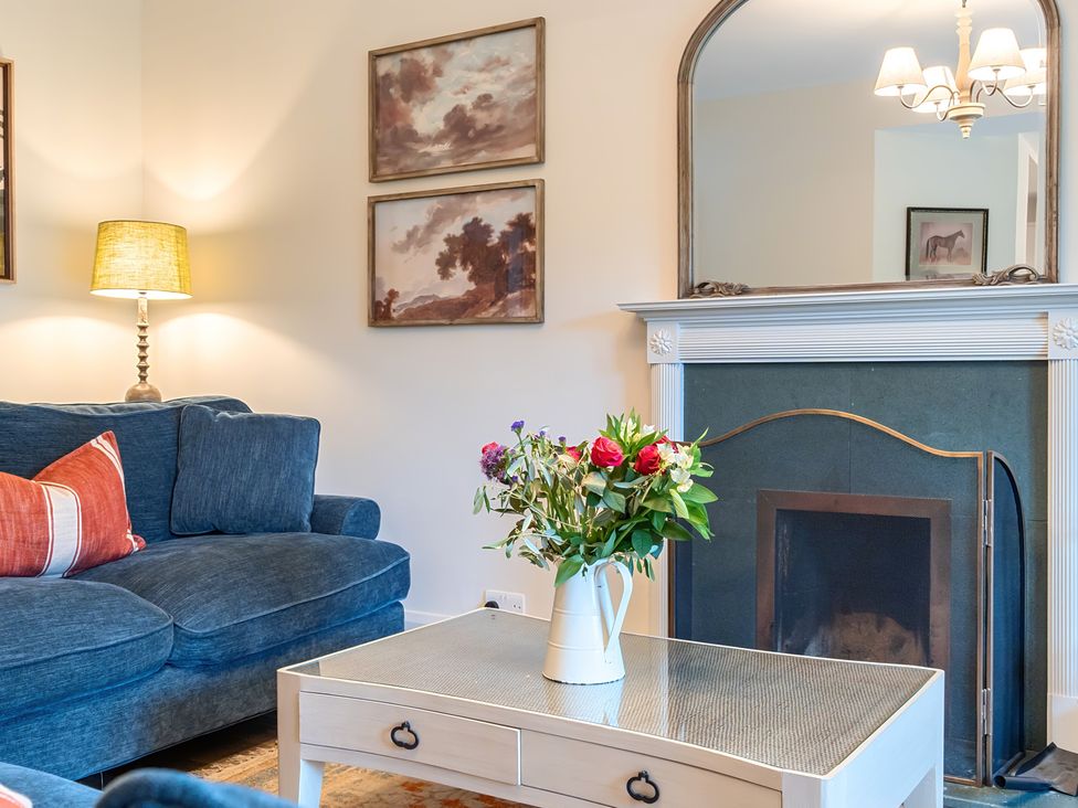 A living room with a sofa, lamp, and coffee table at Jubilee at the Graythwaite Estate Graythwaite near Hawkshead