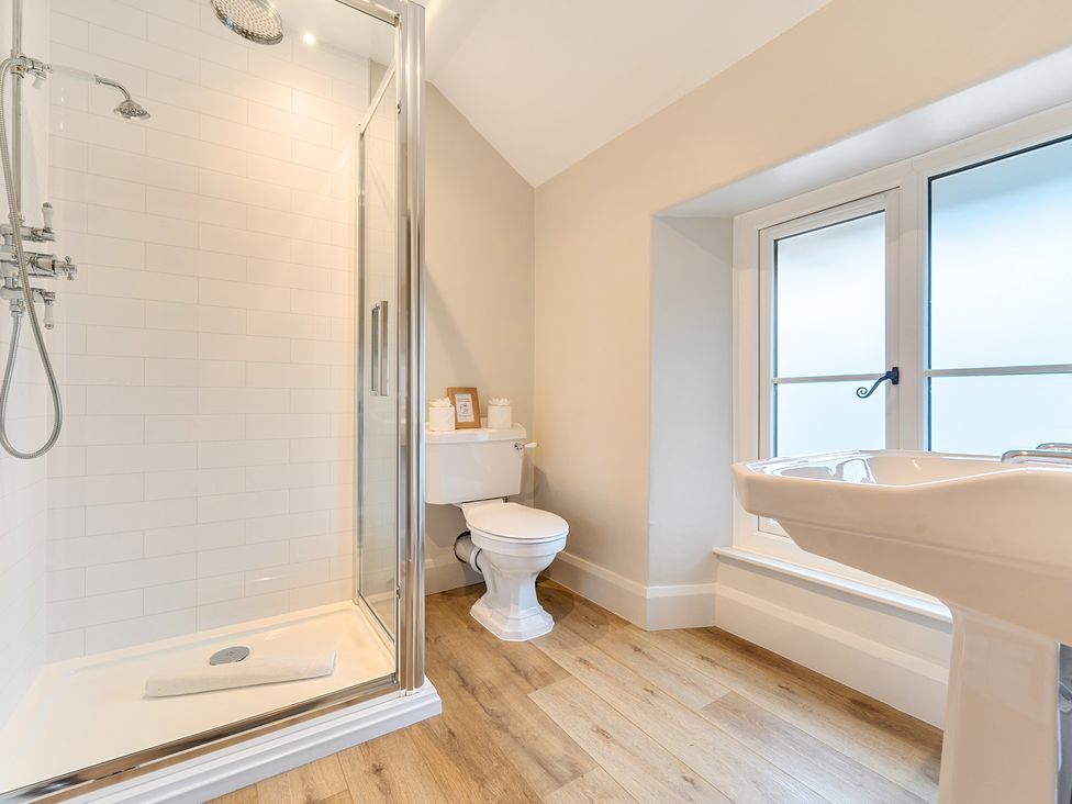 A bathroom with a shower, toilet, and sink at Jubilee at the Graythwaite Estate, Graythwaite near Hawkshead
