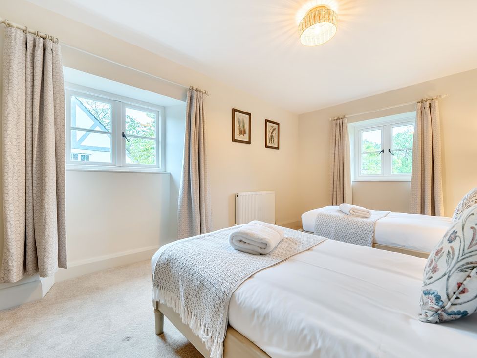 A bedroom with two beds and a window at Jubilee at the Graythwaite Estate in Graythwaite near Hawkshead