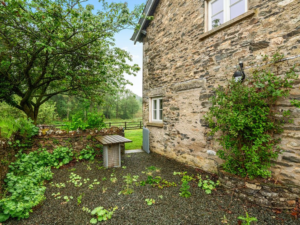 An outdoor area with a stone wall and gravel at Jubilee at the Graythwaite Estate Graythwaite near Hawkshead