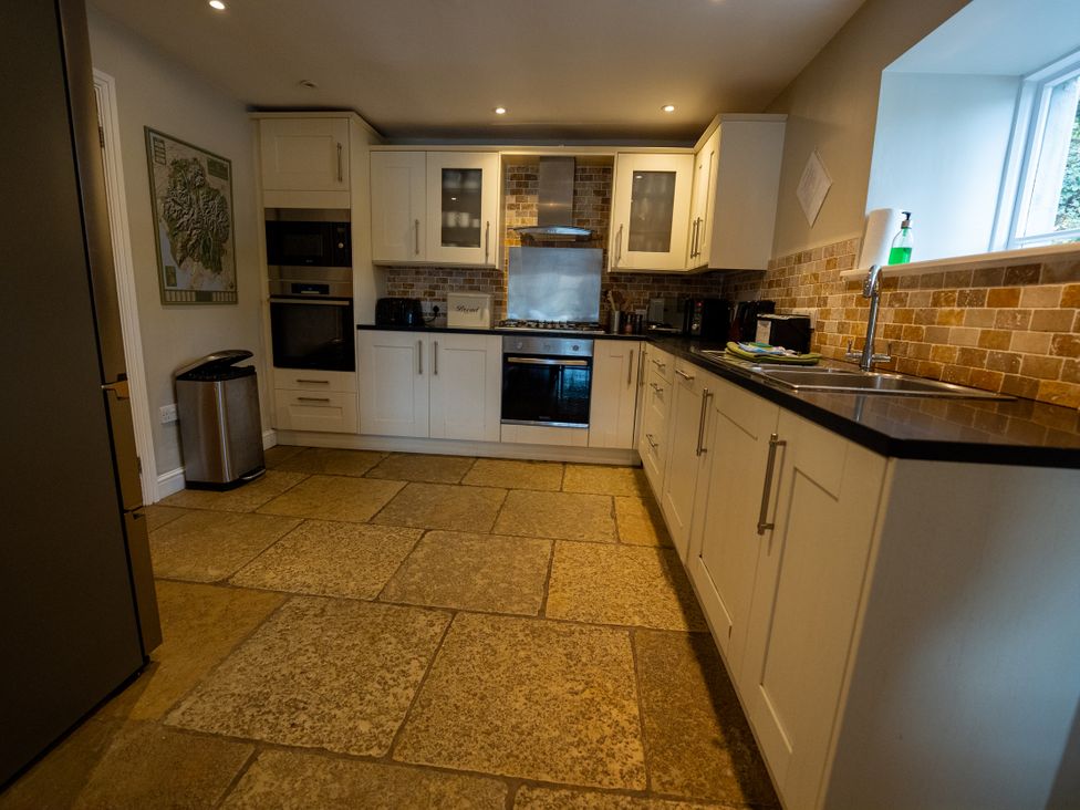 A kitchen with appliances and countertops at Hammerhole Graythwaite near Hawkshead