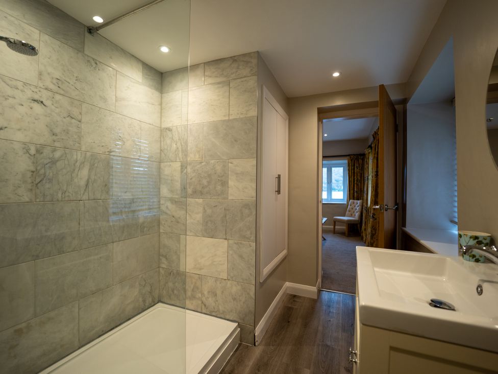 A bathroom with a shower and vanity unit at Hammerhole in Graythwaite near Hawkshead