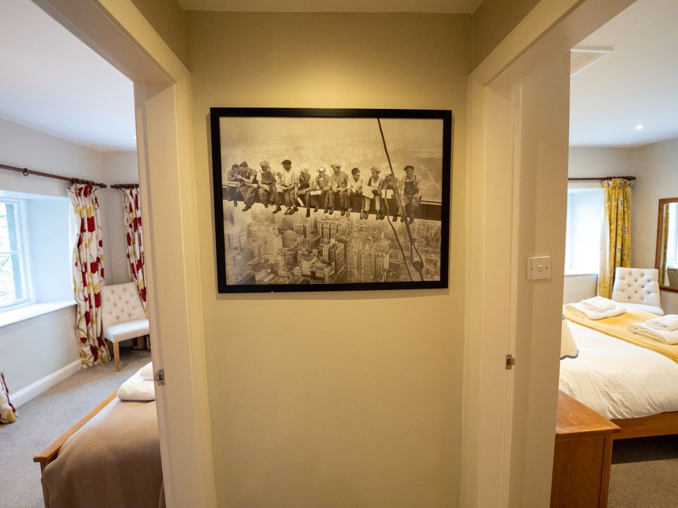 A bedroom with a photo on the wall at Hammerhole in Graythwaite near Hawkshead