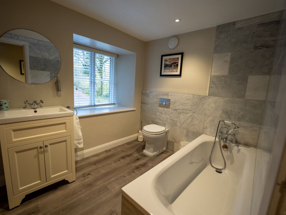 A bathroom with a sink, toilet, and bathtub at Hammerhole in Graythwaite near Hawkshead