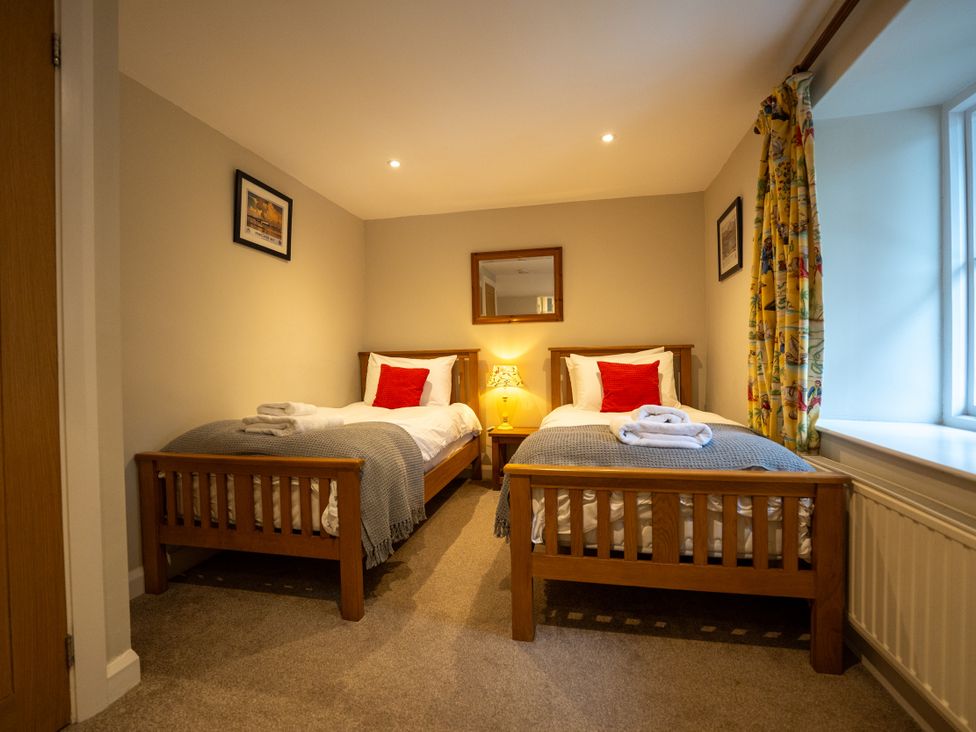 A bedroom with two single beds at Hammerhole in Graythwaite near Hawkshead