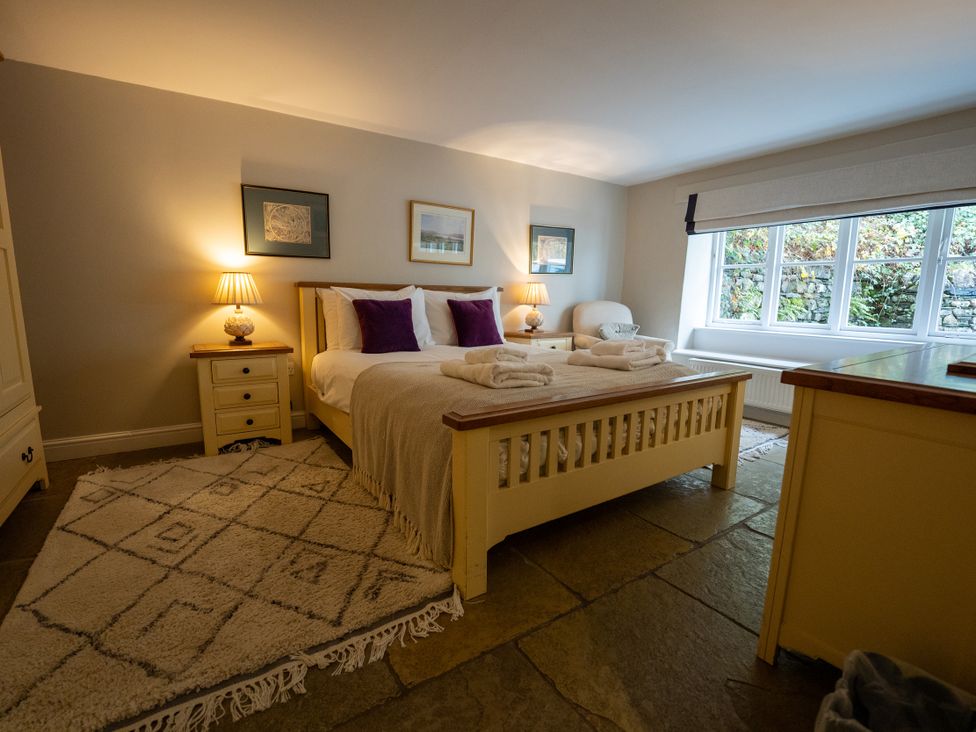 A bedroom with a bed and nightstand at Hammerhole in Graythwaite near Hawkshead