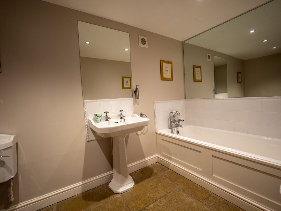 A bathroom with a sink and bathtub at Hammerhole in Graythwaite near Hawkshead