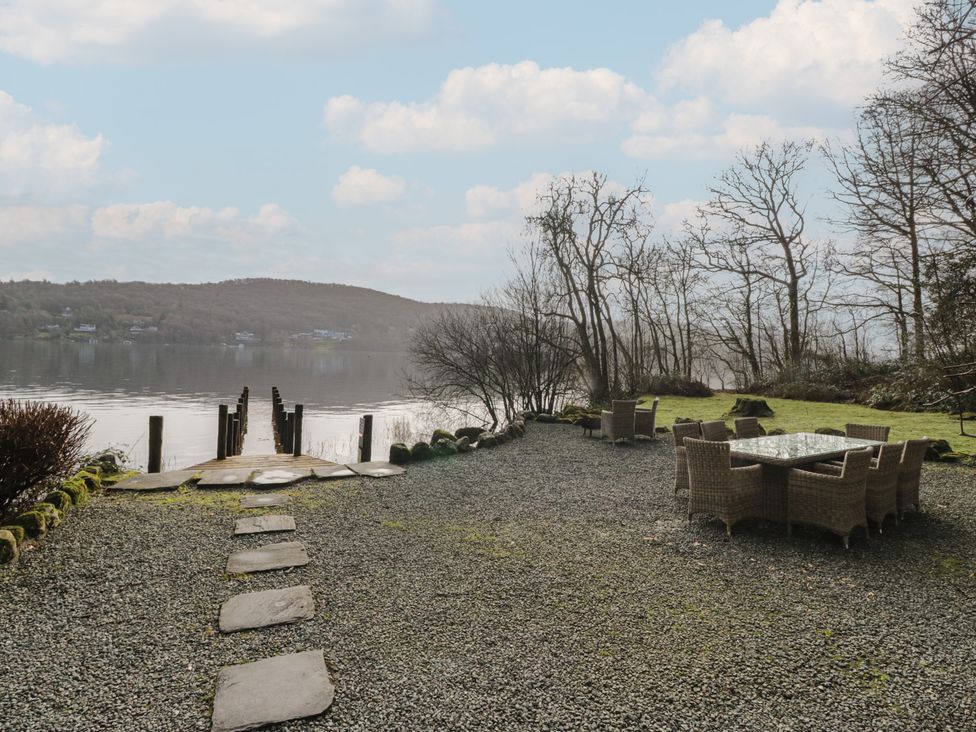 An outdoor dining area with a view of the lake at Hammerhole in Graythwaite near Hawkshead
