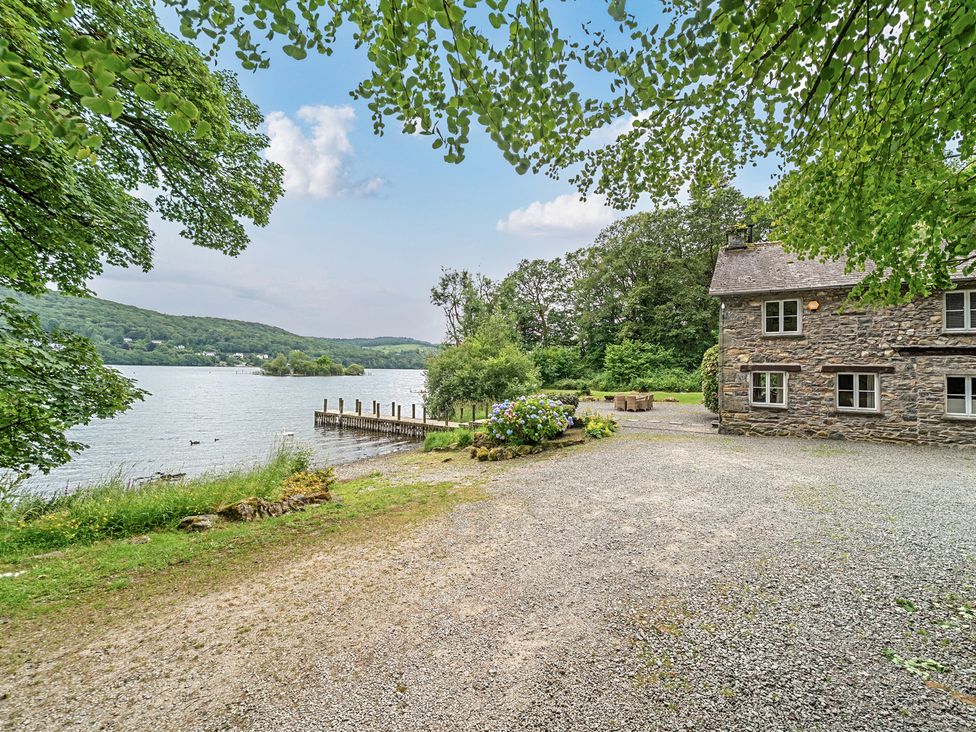 An outdoor view of a lake and a house at Hammerhole at the Graythwaite Estate near Hawkshead