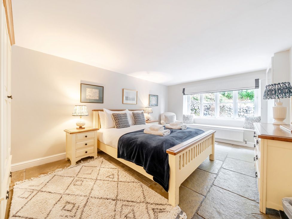 A bedroom with a bed and bedside tables at Hammerhole at the Graythwaite Estate near Hawkshead