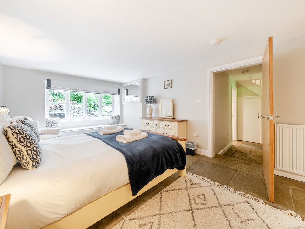 A bedroom with a bed and window at Hammerhole at the Graythwaite Estate near Hawkshead