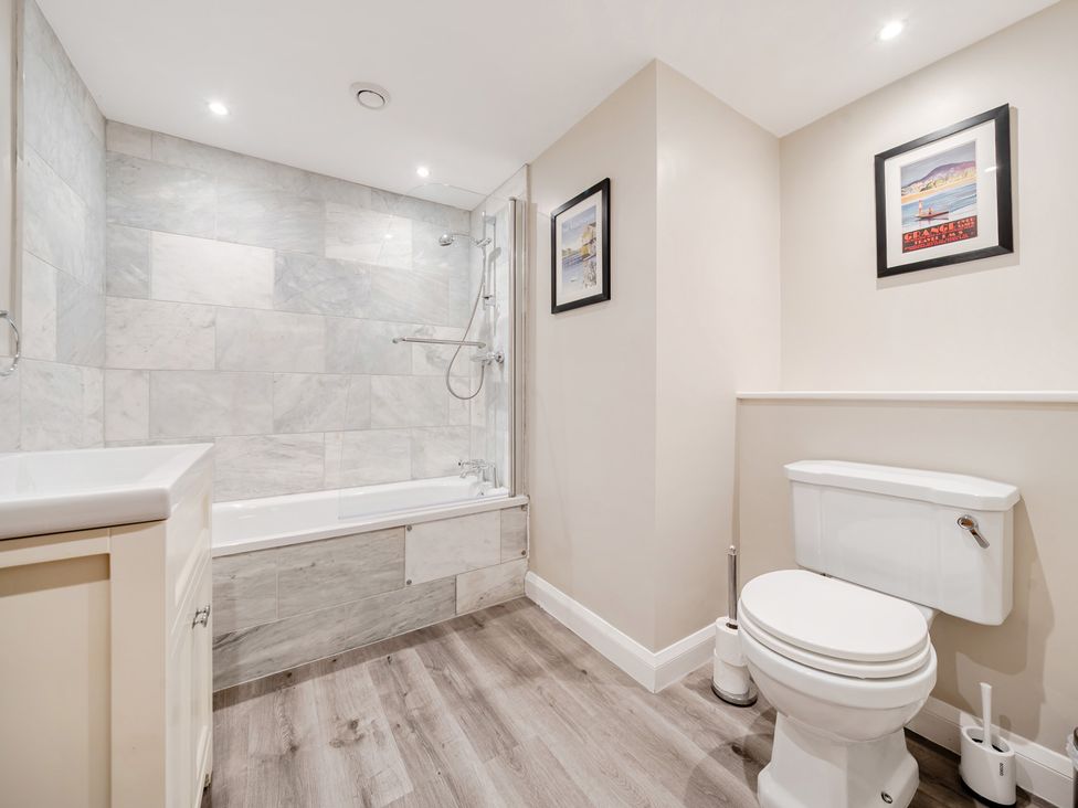 A bathroom with a bathtub, shower, sink, and toilet at Hammerhole at the Graythwaite Estate near Hawkshead